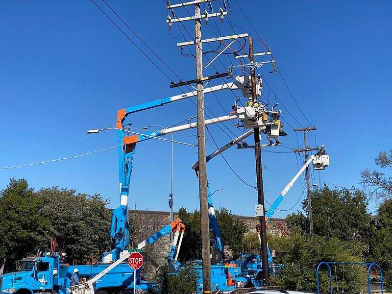 Pg&Amp;E Trucks Work On Power Lines