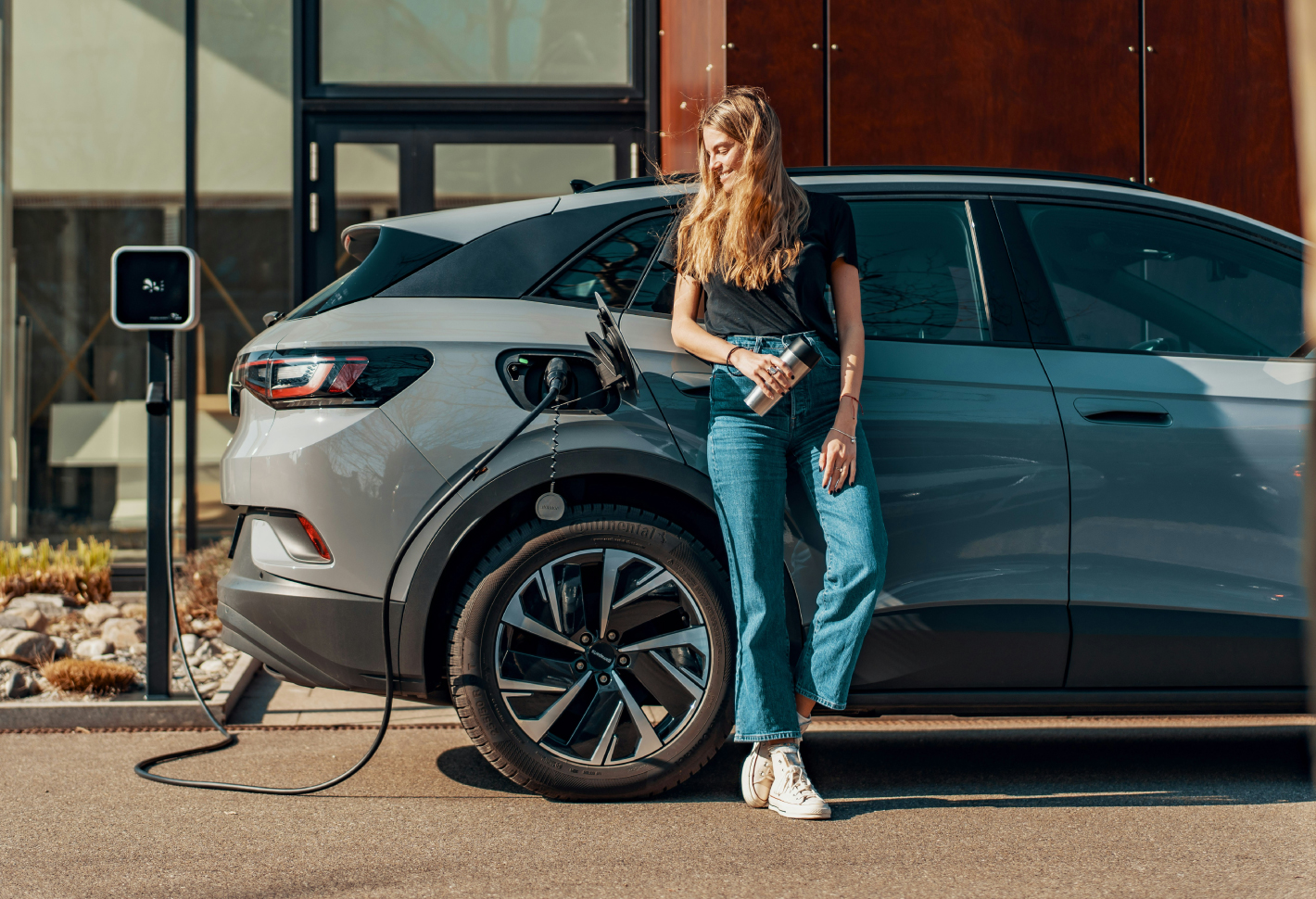 person charging electric car