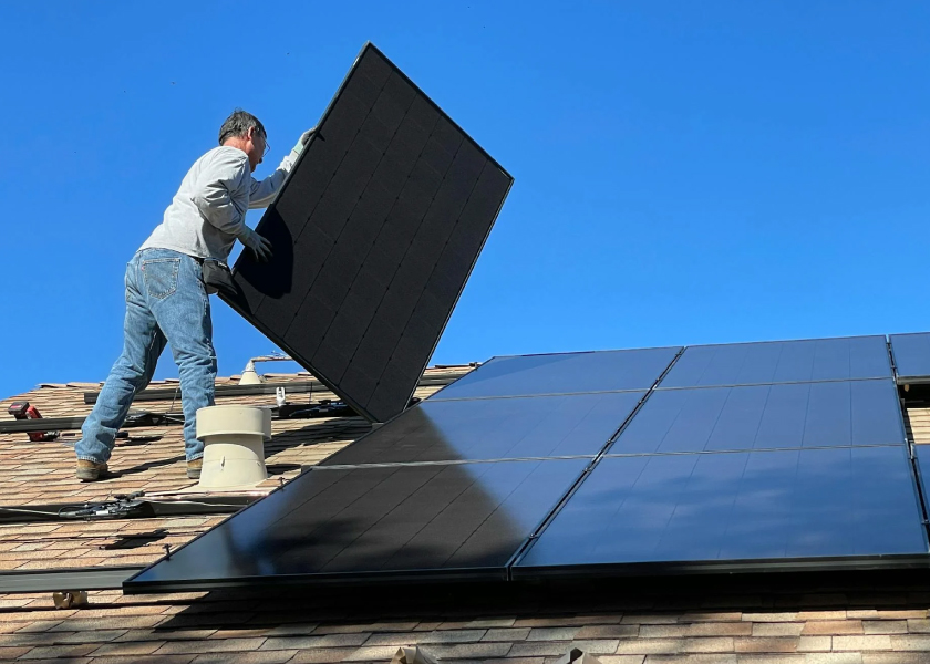 man installing solar panel