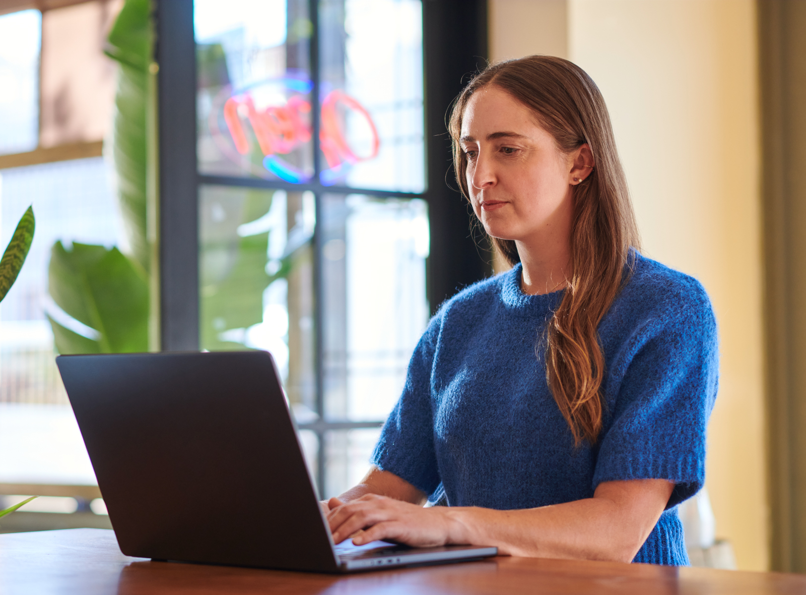 Woman reading an article on a laptop