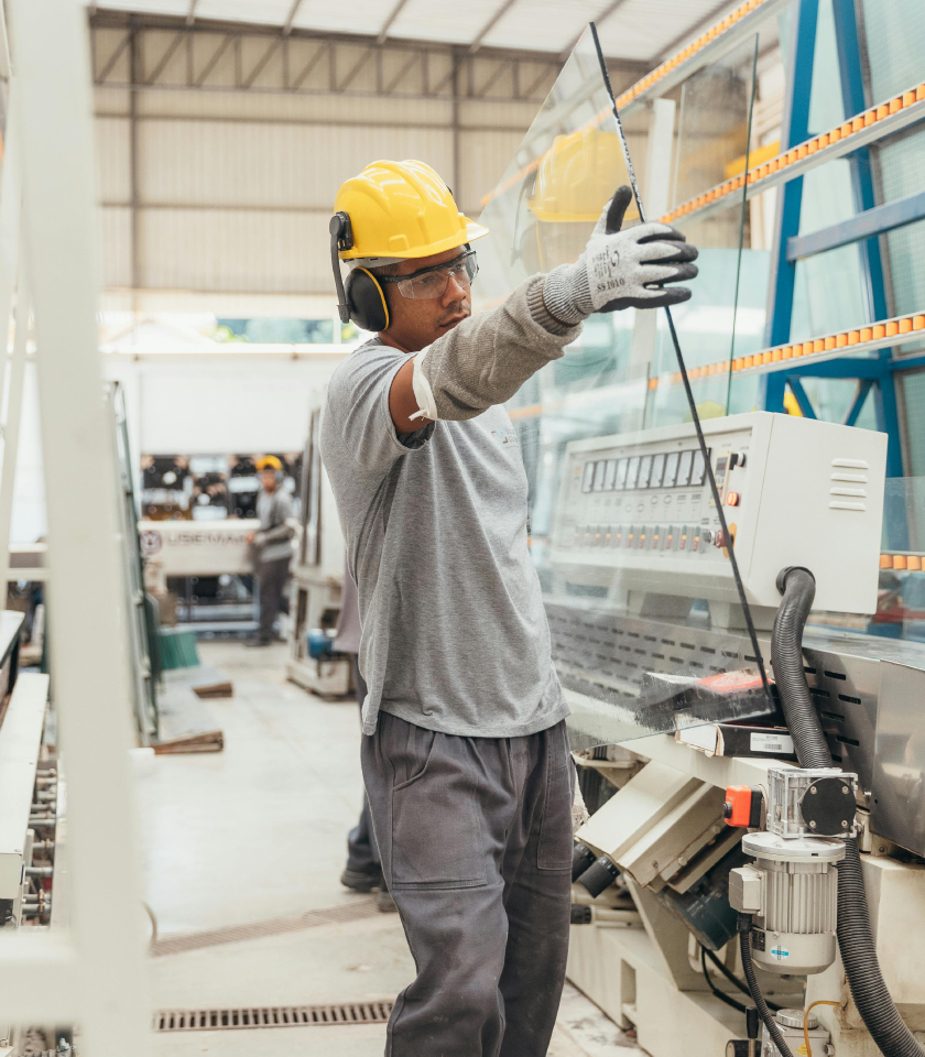 Man moving glass in a business industrial setting
