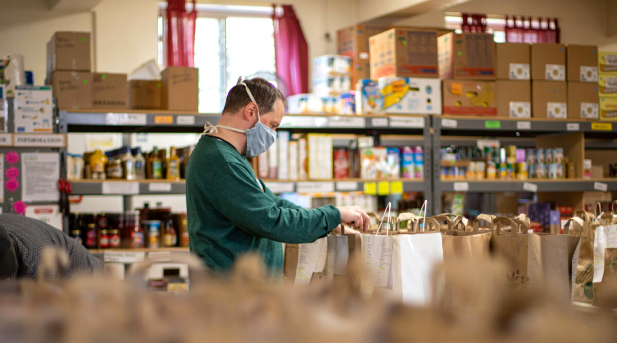 Man Packing Produce At A Food Distribution Center
