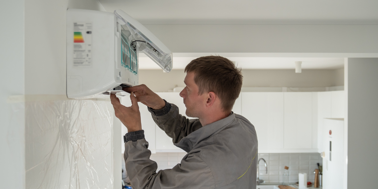 Person Installing Heat Pump Mini Split System