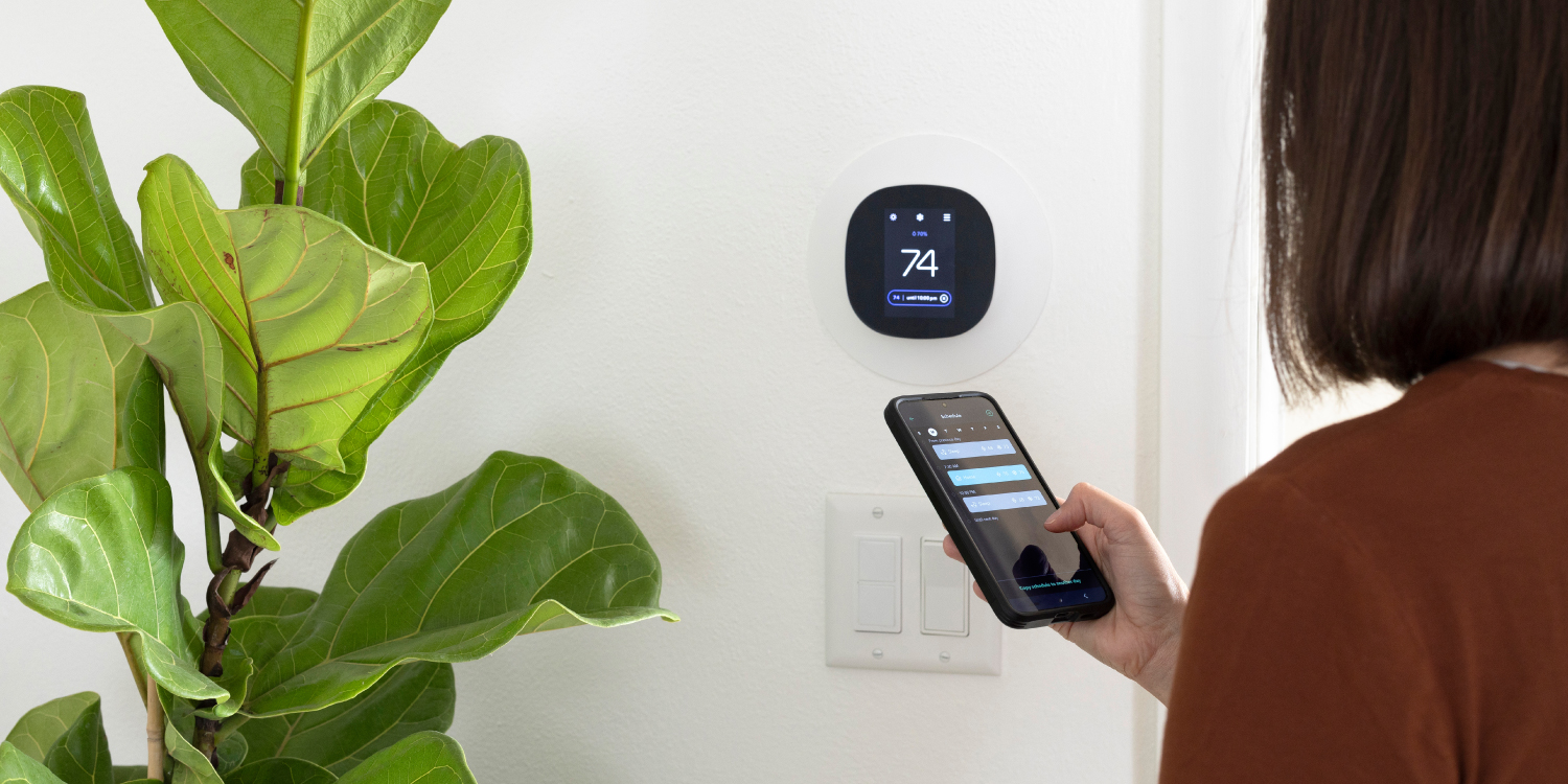 Woman Programming Smart Thermostat