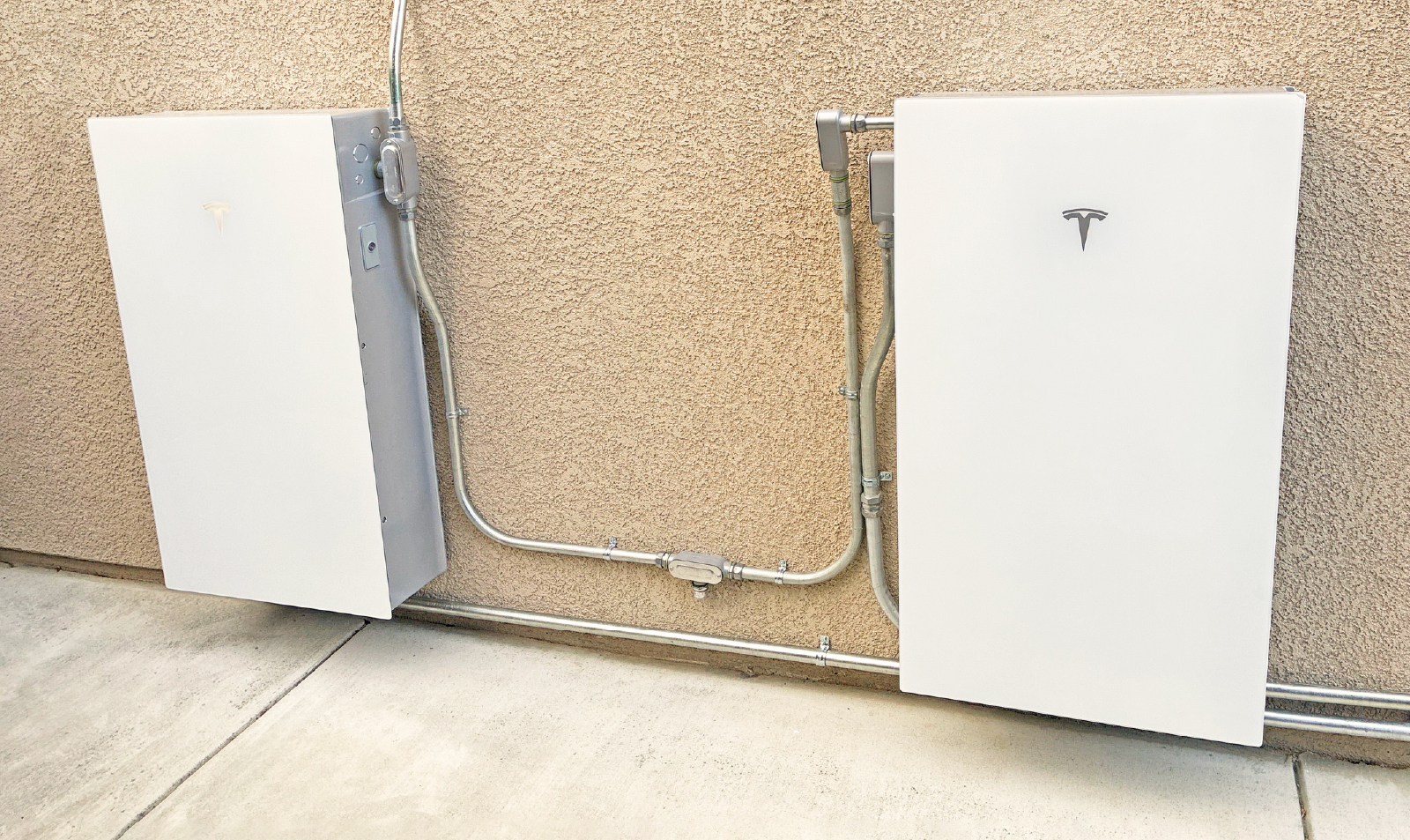 Tesla Powerwall Batteries Installed On A House's Exterior