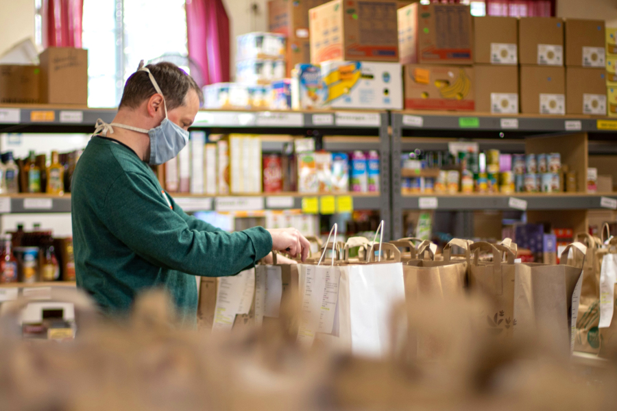 Masked Person Working At Food Pantry